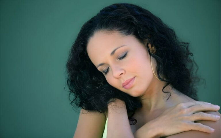 Woman holding neck in pain, showing neck pain discomfort and tension