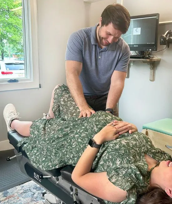 Pregnant woman receiving a gentle prenatal chiropractic adjustment for back and hip comfort
